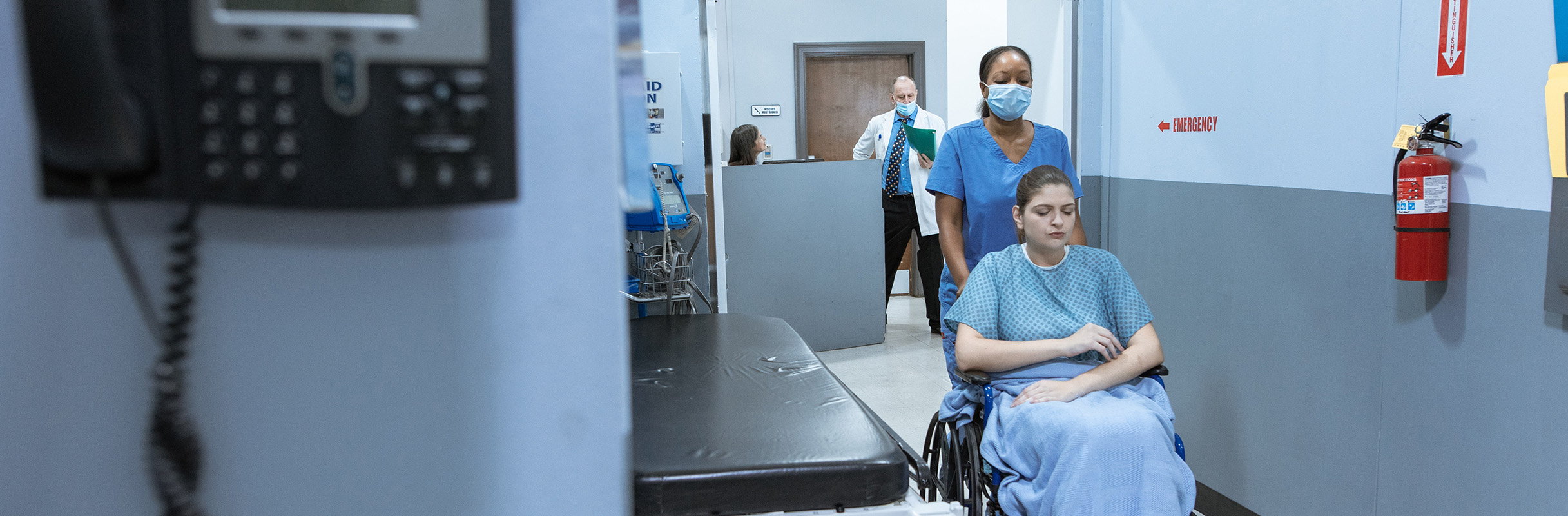 Emergency Nurse beside sign