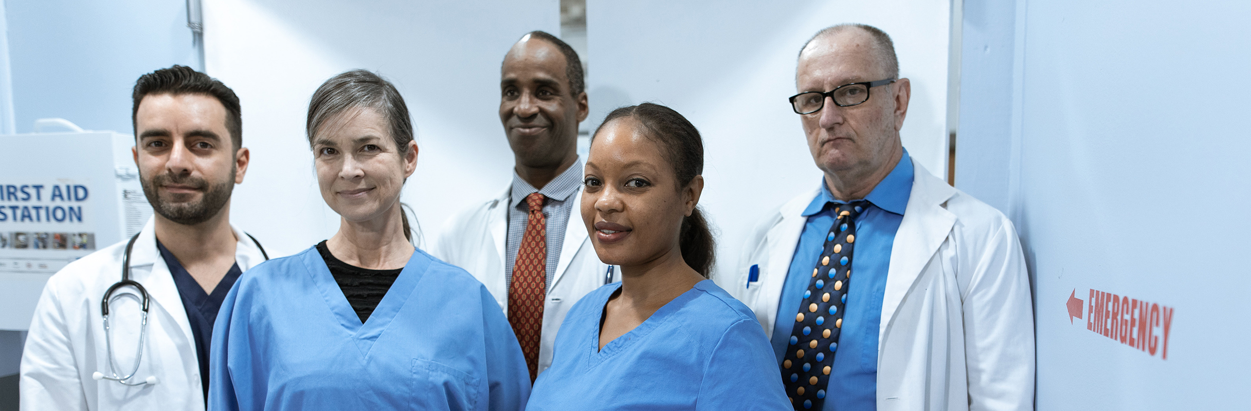 Emergency Nurse beside sign