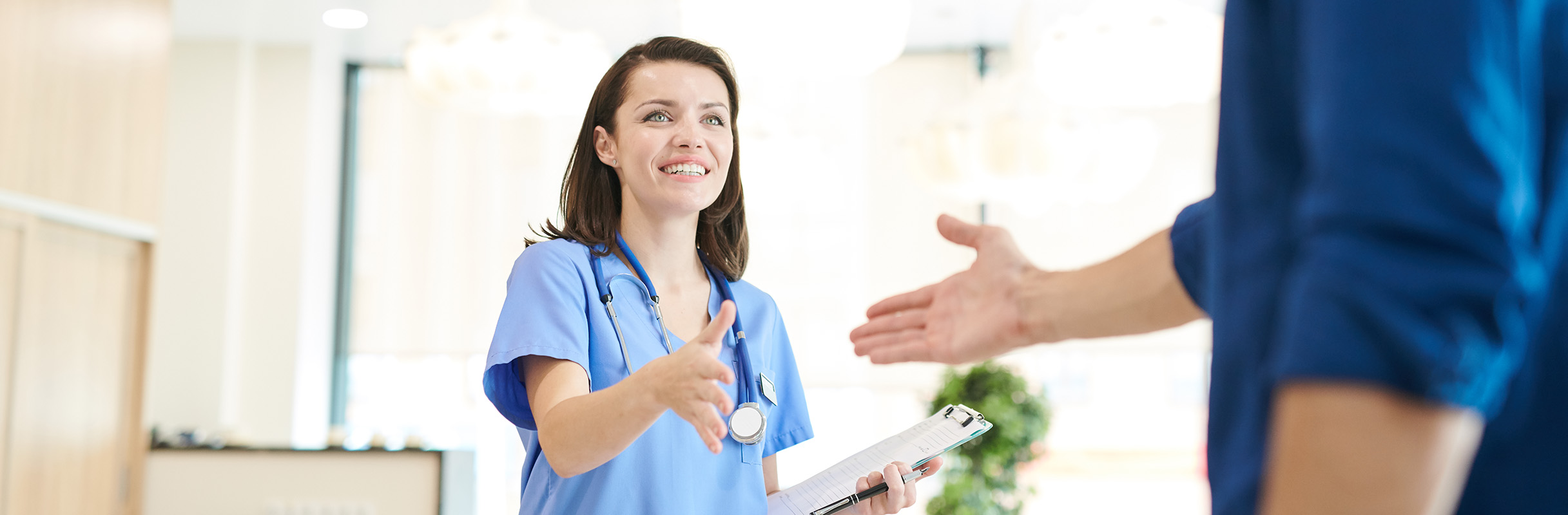 Emergency Nurse beside sign